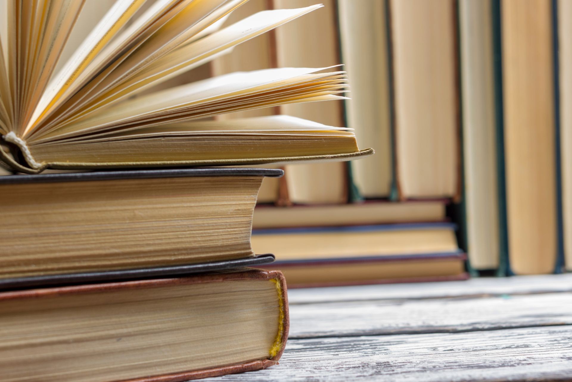 Open book, hardback books on wooden table. Back to school. Copy space